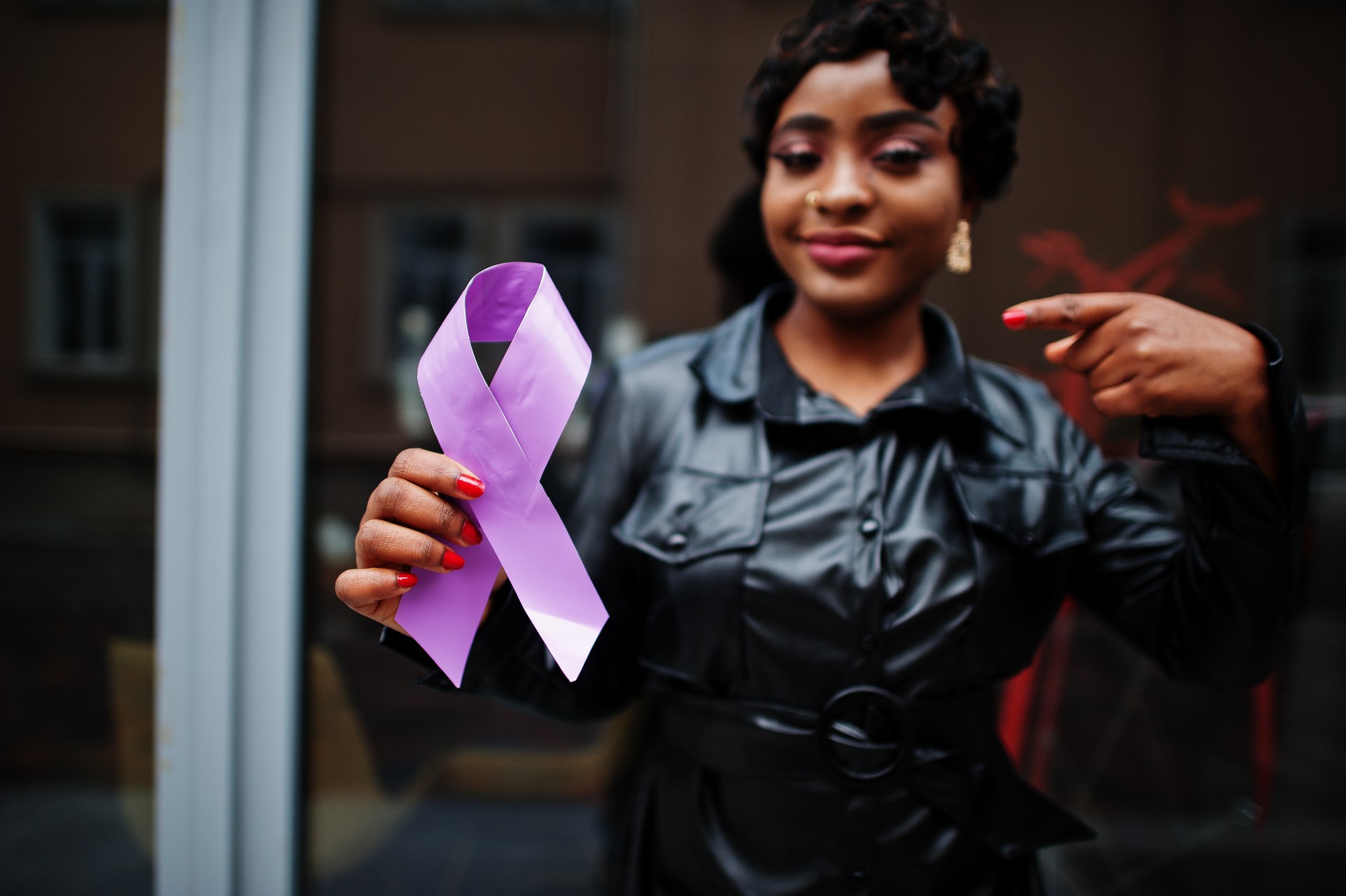 African american woman hold purple ribbon awareness.