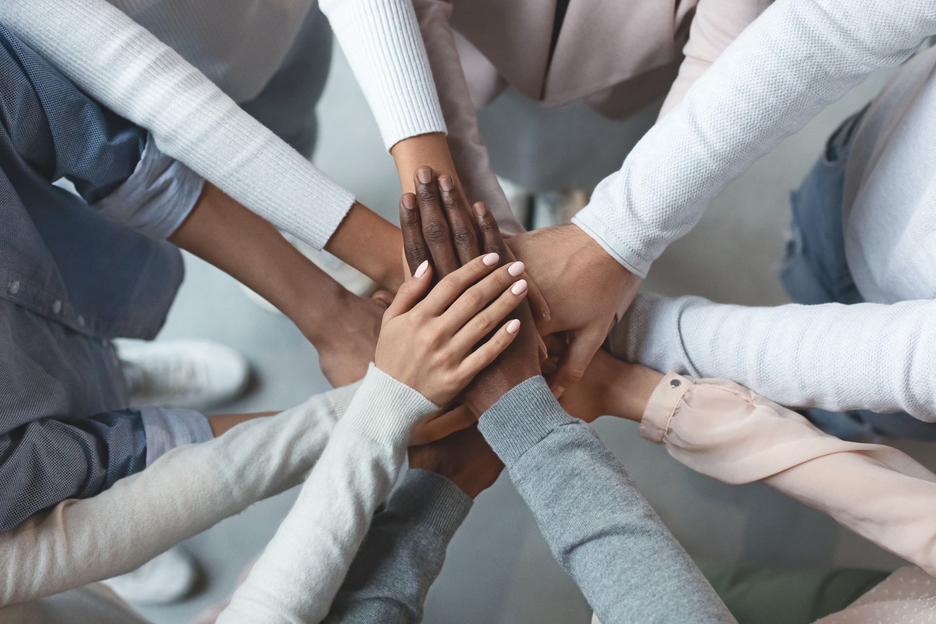 Business team putting hands together on top of each other